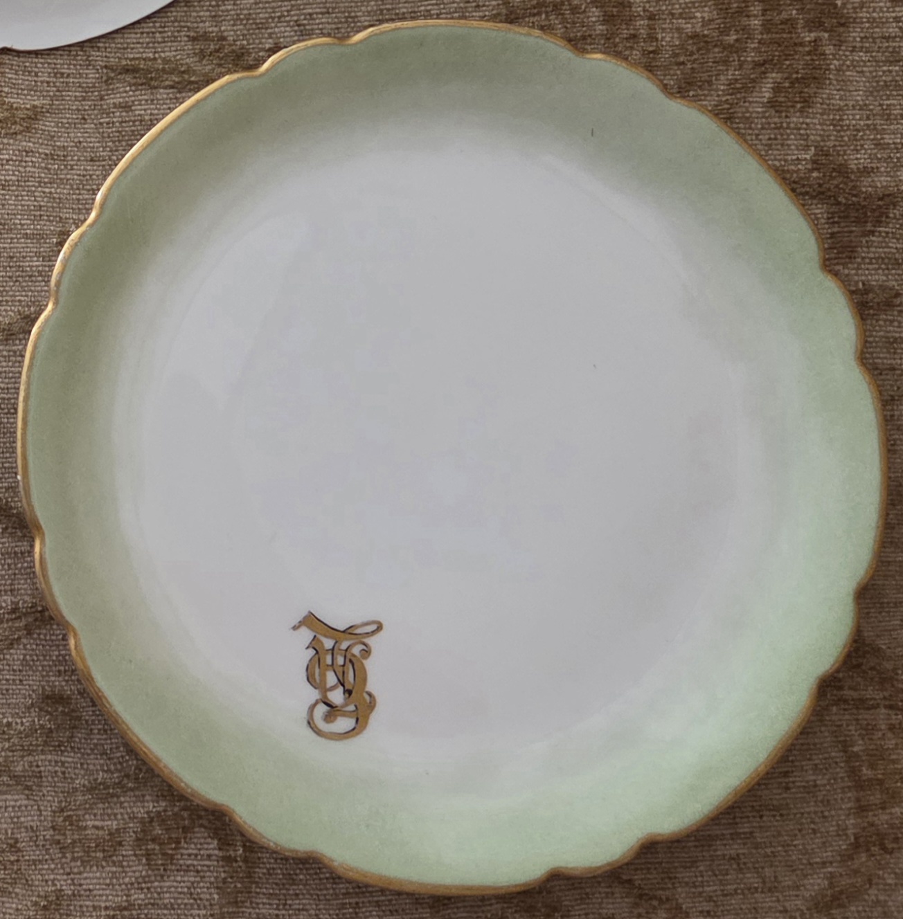 3 white plates 6.5" Diameter with 1" Lt Green outer ring plus Gold leaf around scalloped edge with Gold leaf initials on the plate — appraisal value $90 - $150