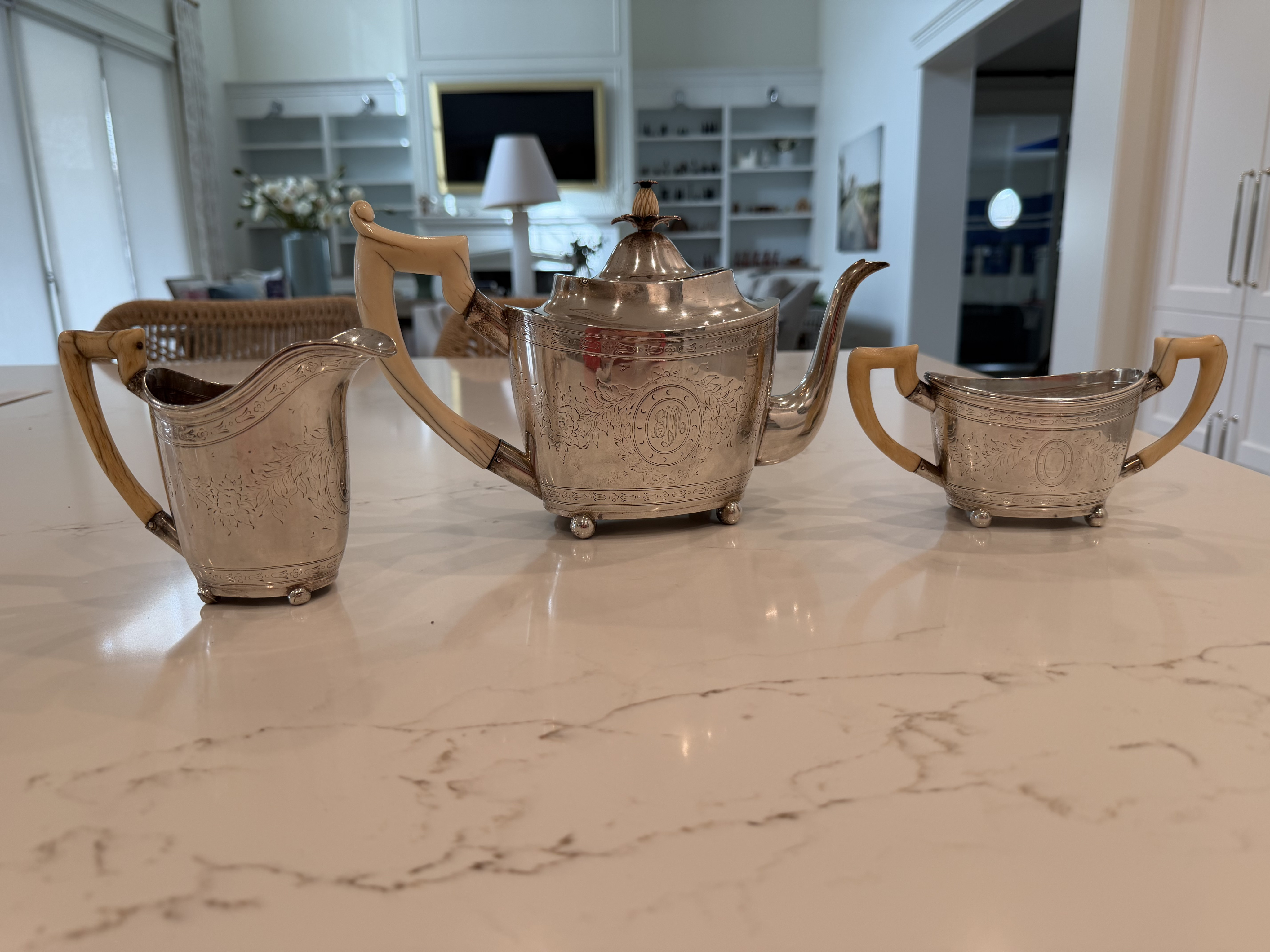 Silver and tea pot, creamer and sugar with ivory handles 