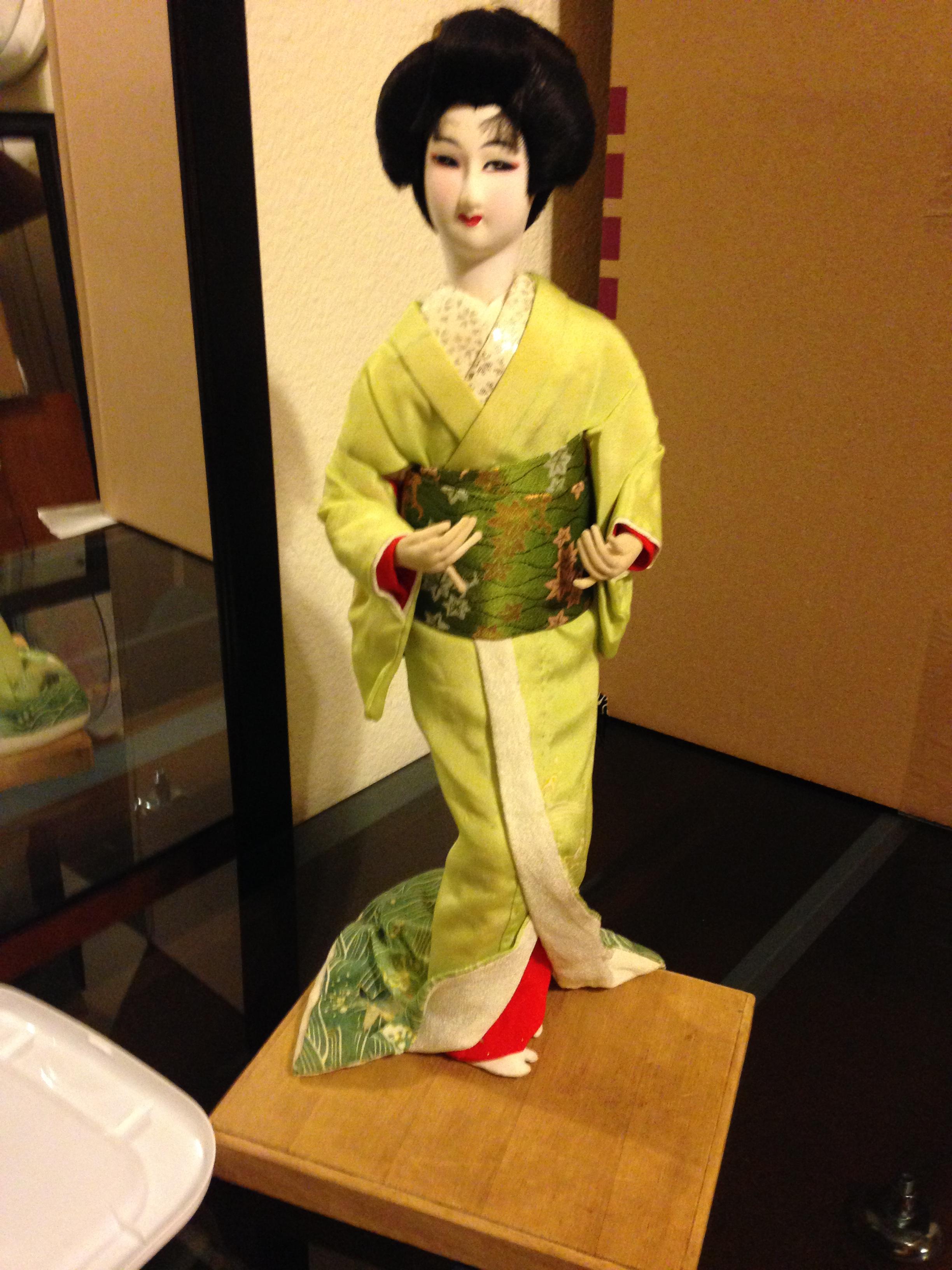 14 inch Japanese doll on wood platform InstAppraisal