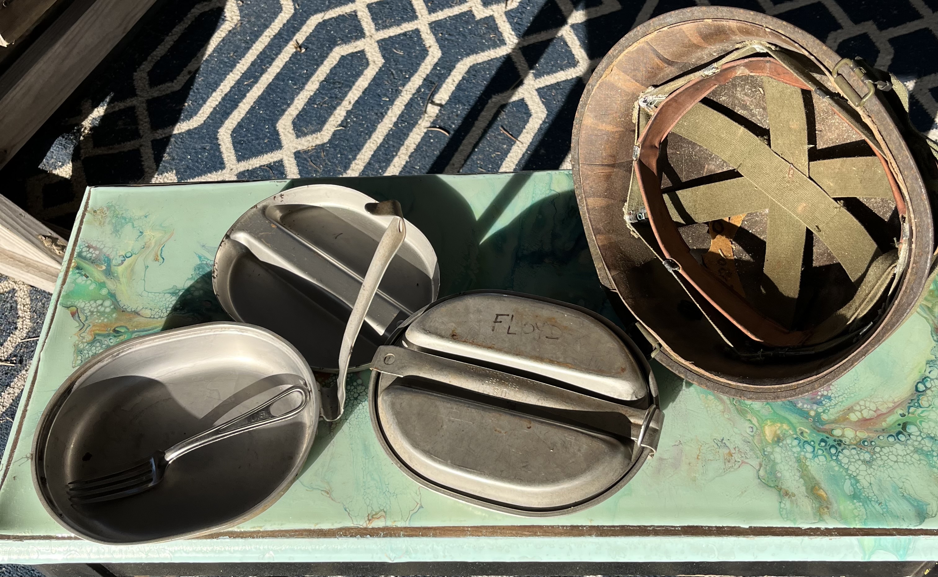 Military helmet and mess kits.