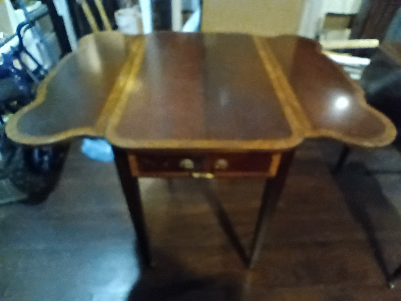I believe it to be a Pembroke drop leaf table