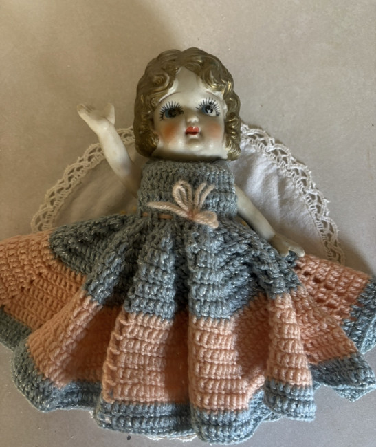 Old hand-painted, porcelain doll with handmade crocheted, dress, movable arms