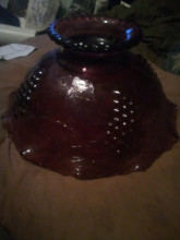 Purple glass candy dish with grapes on the outside 