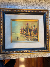 Painting of tower/castle on water with boat