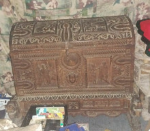 Antique, heavily carved oak coffer, possibly dating back to the 17th or 18th century.