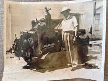 Vintage photograph of man in front of vehicle marked Capitol Welding Co