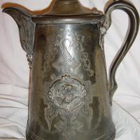 Pewter Pitcher with a lady riding a bat.