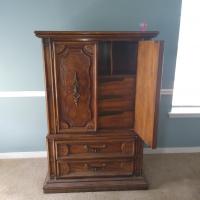 Tall chester with the top drawers hidden by swinging doors