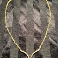 14 karat gold, natural diamonds. Jane length 18 inches not including the V cut diamond area.