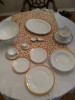 Place setting with dinner,salad,bread plates, soup bowls, coffee and deitiase cups